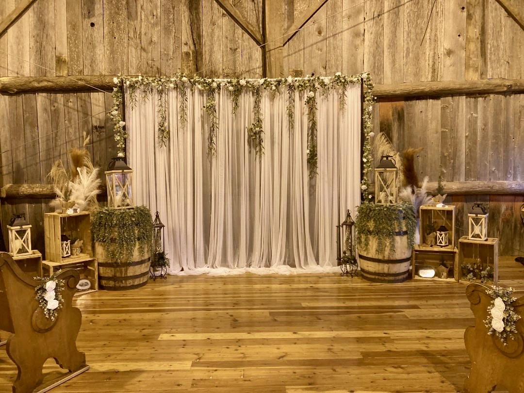 Wedding ceremony backdrop in the barn