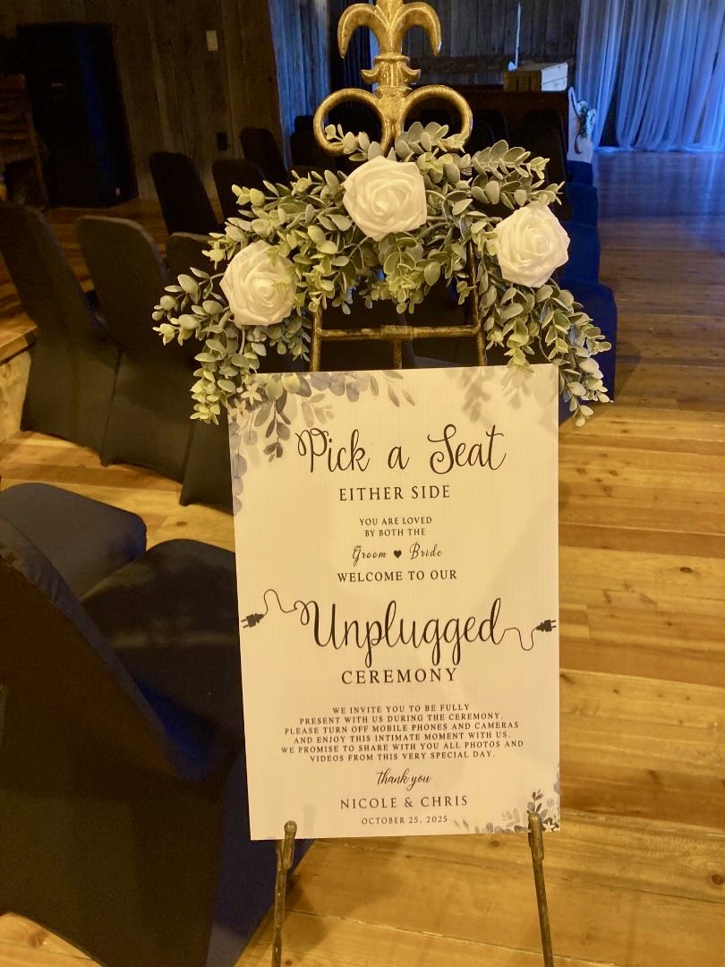 Elegant wedding welcome sign with white roses and greenery
